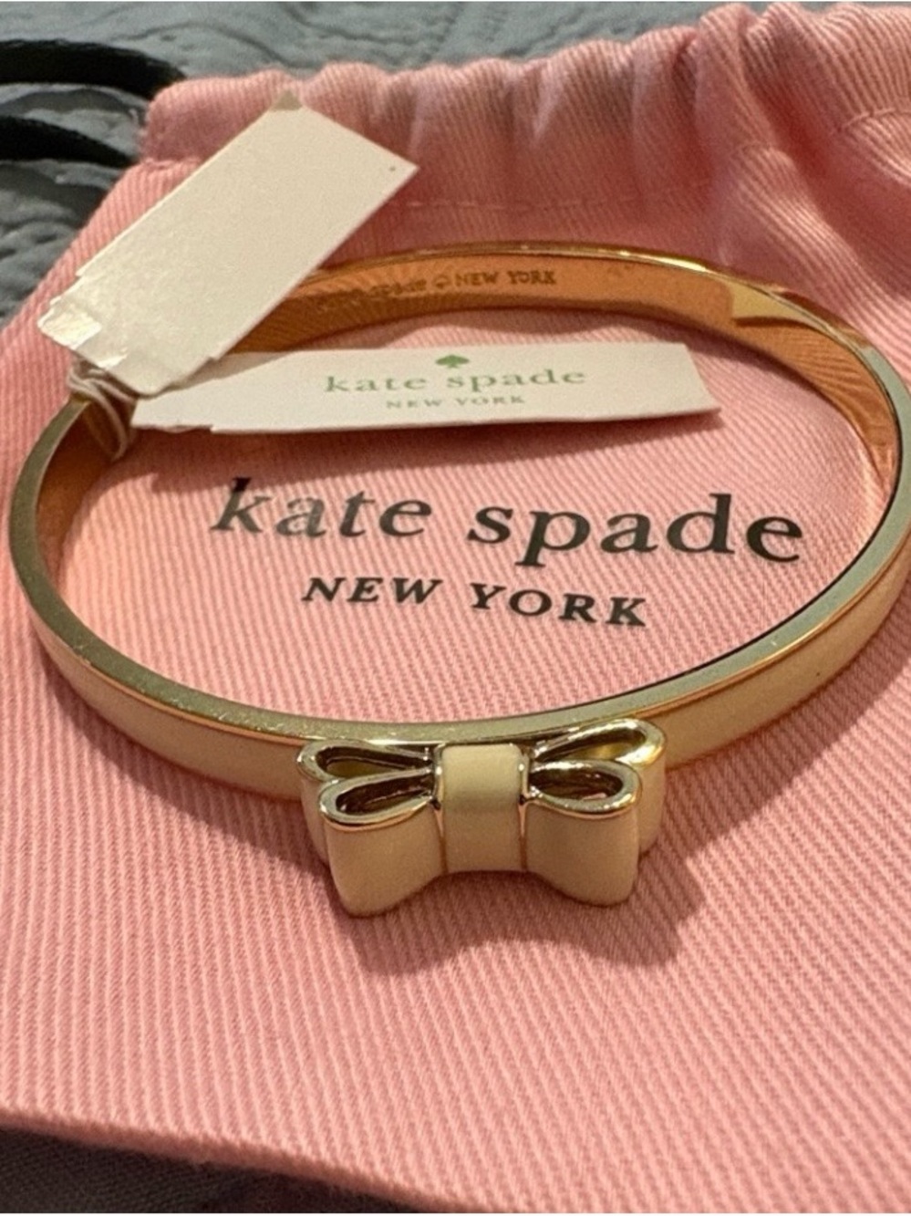 kate spade gold-tone bangle with cream enamel bow